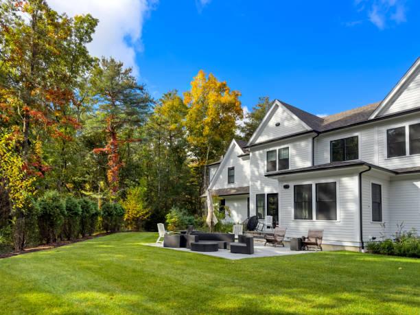 Vermont home with green lawn and patio